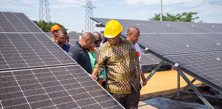 Gauteng premier Panyaza Lesufi leads a delegation in Alex to assess the progress of a micro-grid solar grid project.